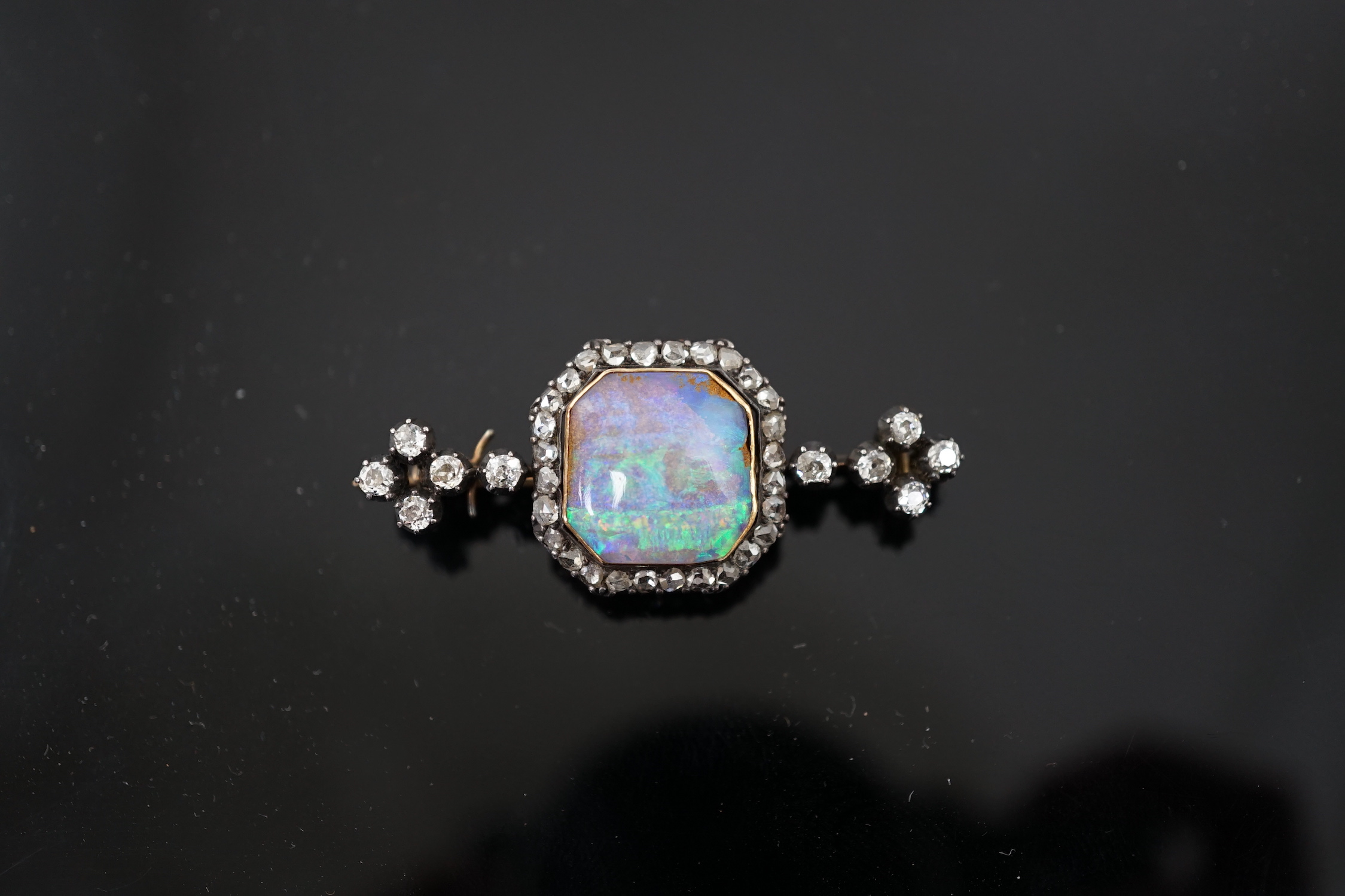 A late Victorian gold and silver, black opal and diamond cluster bar brooch